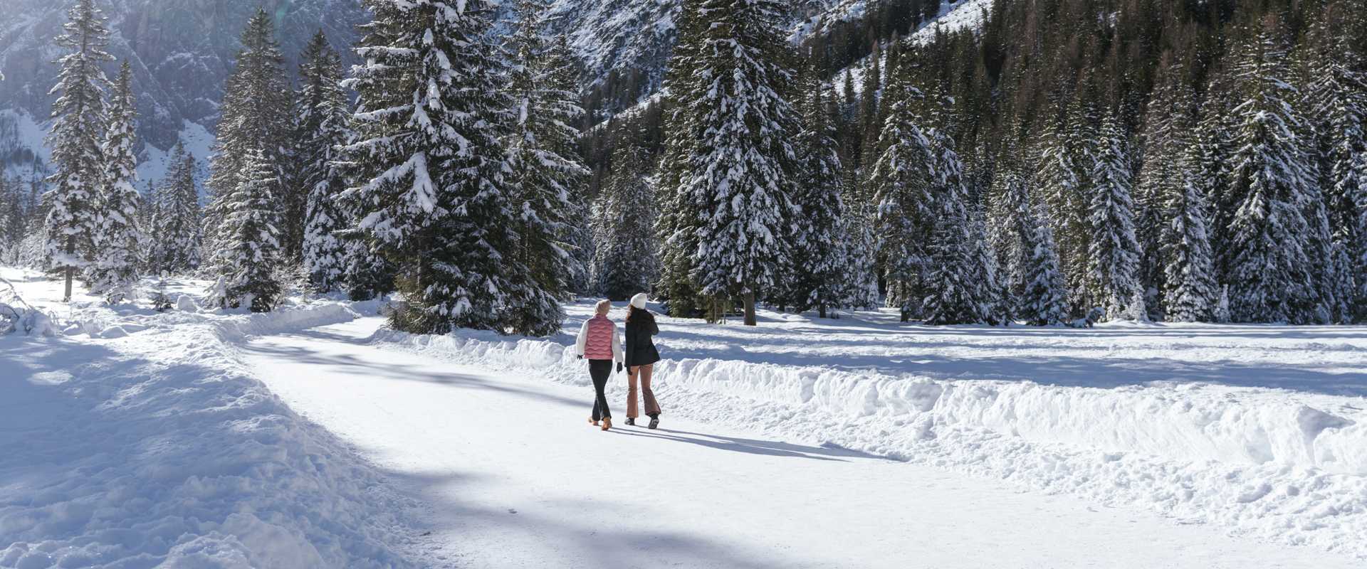 2 donne su un sentiero escursionistico invernale con panorama sulle Dolomiti in Val Fiscalina